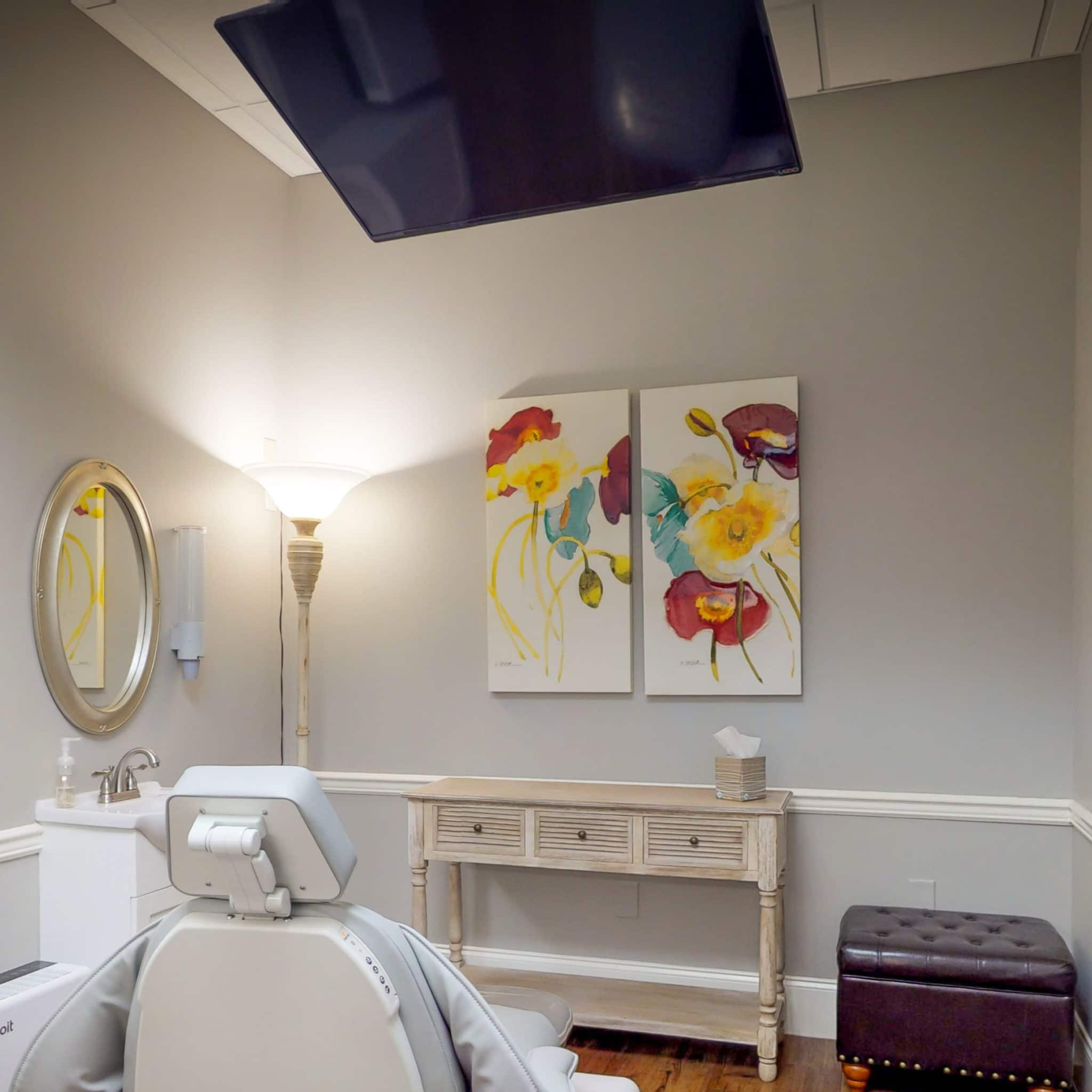 TV mounted above a dental chair in a Smiles on Main treatment room